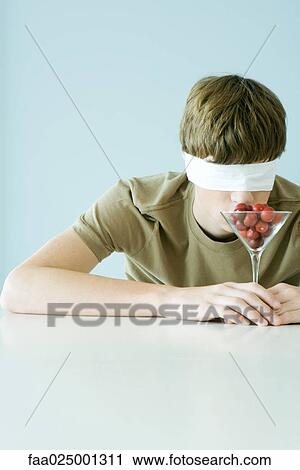 Young male wearing blindfold, smelling glass full of cherry tomatoes View Large Photo Image Stock Image - Young male wearing blindfold, smelling glass full of cherry tomatoes. Fotosearch