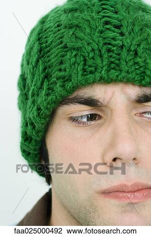 Young man in knit hat looking away, cropped view View Large Photo Image Stock Image - Young man in knit hat looking away, cropped view. Fotosearch
