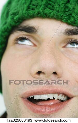 Young man in knit hat making faces, close-up View Large Photo Image Stock Image - Young man in knit hat making faces, close-up. Fotosearch