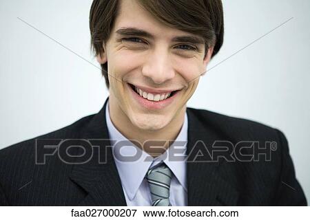 Young man in suit smiling at camera, portrait, close-up View Large Photo Image Stock Photo - Young man in suit smiling at camera, portrait, close-up. Fotosearch