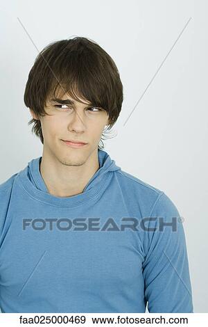 Young man looking away, close-up View Large Photo Image Stock Photo - Young man looking away, close-up. Fotosearch