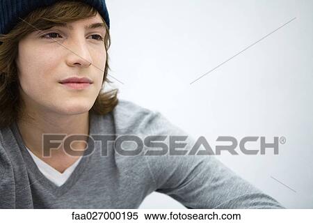 Young man looking away, portrait, close-up View Large Photo Image Stock Photography - Young man looking away, portrait, close-up. Fotosearch