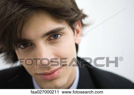 Young man smiling at camera, portrait View Large Photo Image Stock Image - Young man smiling at camera, portrait. Fotosearch