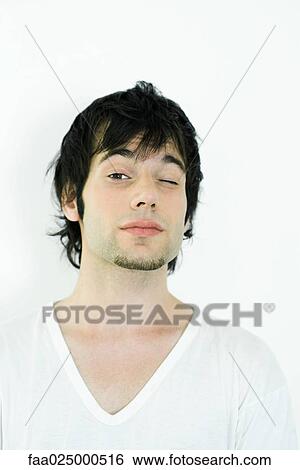 Young man with goatee winking at camera, portrait View Large Photo Image Stock Photograph - Young man with goatee winking at camera, portrait. Fotosearch