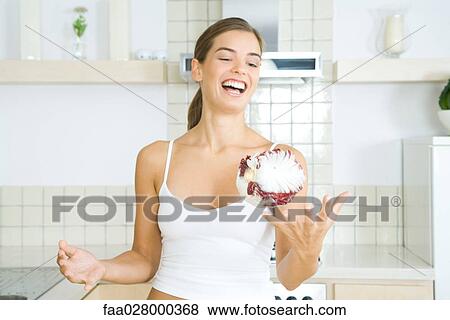 Young woman in kitchen, tossing chicory in the air, laughing View Large Photo Image Stock Photo - Young woman in kitchen, tossing chicory in the air, laughing. Fotosearch