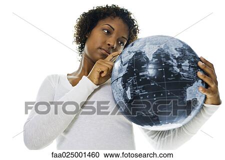 Young woman looking at globe and pointing with finger View Large Photo Image Stock Image - Young woman looking at globe and pointing with finger. Fotosearch