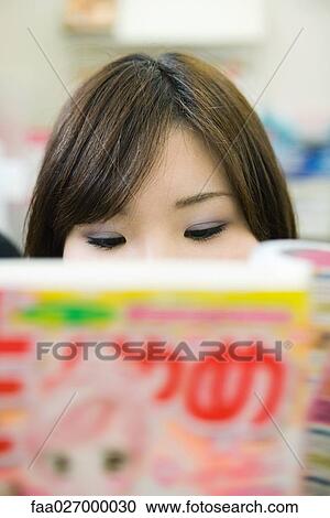Young woman reading manga-style comic book, extreme close-up, cropped View Large Photo Image Stock Image - Young woman reading manga-style comic book, extreme close-up, cropped. Fotosearch