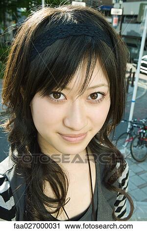 Young woman smiling at camera, portrait View Large Photo Image Stock Image - Young woman smiling at camera, portrait. Fotosearch