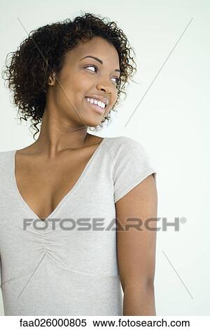 Young woman smiling over shoulder, waist up View Large Photo Image Stock Photography - Young woman smiling over shoulder, waist up. Fotosearch