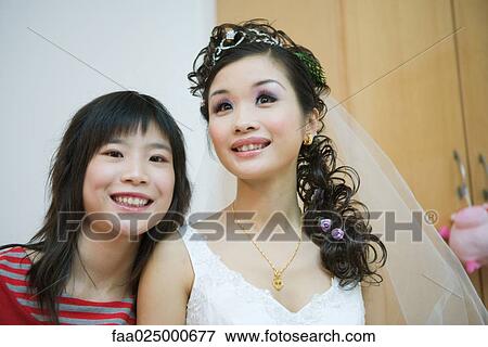 Young woman smiling with bride, head and shoulders, portrait View Large Photo Image Stock Photo - Young woman smiling with bride, head and shoulders, portrait. Fotosearch