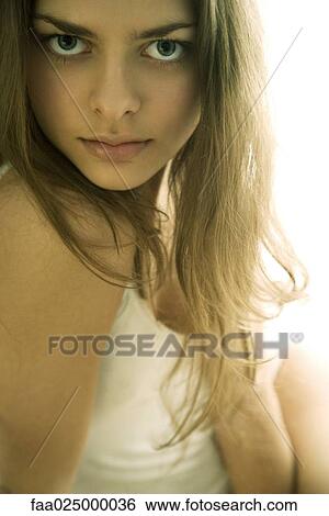 Young woman staring over shoulder at camera, cropped view View Large Photo Image Stock Photograph - Young woman staring over shoulder at camera, cropped view. Fotosearch