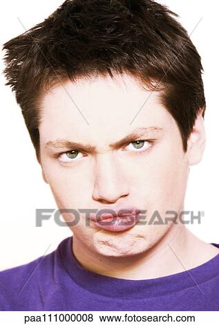 Teenage boy making face, close-up, portrait View Large Photo Image Stock Photo - Teenage boy making face, close-up, portrait. Fotosearch