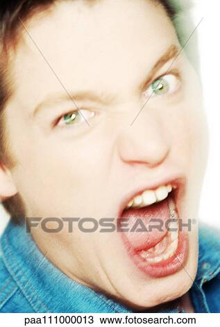 Stock Image - Teenage boy shouting, close-up, portrait. Fotosearch