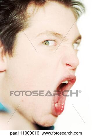 Stock Photograph - Teenage boy shouting, close-up, portrait. Fotosearch