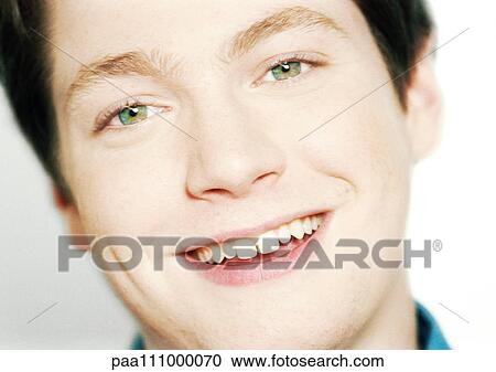 Stock Image - Teenage boy smiling, close-up. Fotosearch
