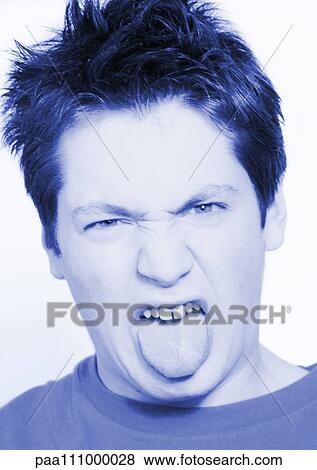 Teenage boy sticking out tongue, close-up, portrait View Large Photo Image Stock Photo - Teenage boy sticking out tongue, close-up, portrait. Fotosearch
