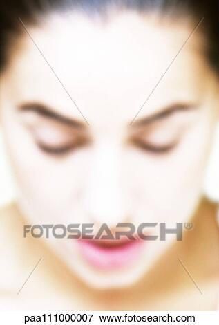Woman looking down, close-up, blurred View Large Photo Image Stock Photo - Woman looking down, close-up, blurred. Fotosearch