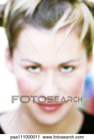Stock Image - Woman's face, close-up, portrait, blurred. Fotosearch