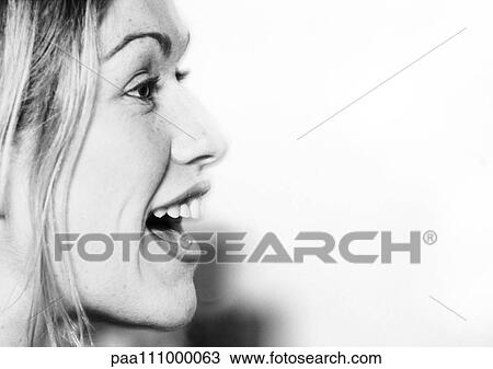 Stock Image - Woman's face with mouth open, side view, close-up, b&w. Fotosearch