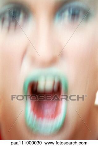 Stock Image - Woman's made-up face, close-up, blurred motion. Fotosearch