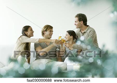 Adult friends clinking champagne glasses, smiling View Large Photo Image Stock Photo - Adult friends clinking champagne glasses, smiling. Fotosearch
