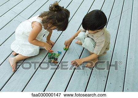 Stock Photo - Boy and girl playing on deck. Fotosearch