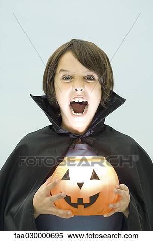 Boy holding jack o'lantern, looking at camera, open mouth, portrait View Large Photo Image Stock Photography - Boy holding jack o'lantern, looking at camera, open mouth, portrait. Fotosearch