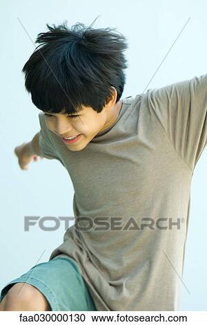 Boy in mid movement View Large Photo Image Stock Image - Boy in mid movement. Fotosearch