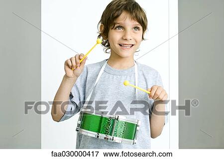 Boy playing toy drum View Large Photo Image Stock Photo - Boy playing toy drum. Fotosearch