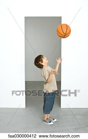 Boy throwing basketball into air View Large Photo Image Stock Image - Boy throwing basketball into air. Fotosearch