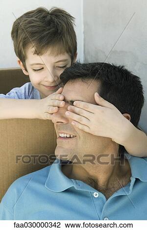 Boy with hands over his father's eyes, both smiling View Large Photo Image Stock Image - Boy with hands over his father's eyes, both smiling. Fotosearch