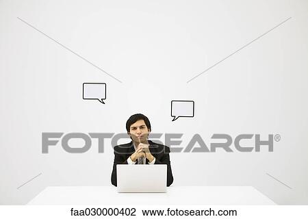 Businessman and word bubbles, looking at camera View Large Photo Image Stock Image - Businessman and word bubbles, looking at camera. Fotosearch