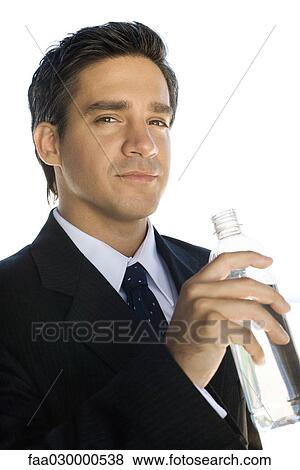 Businessman holding water bottle, looking at the camera, portrait View Large Photo Image Stock Photo - Businessman holding water bottle, looking at the camera, portrait. Fotosearch