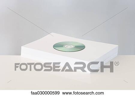 CD on top of stacked paper View Large Photo Image Stock Photo - CD on top of stacked paper. Fotosearch