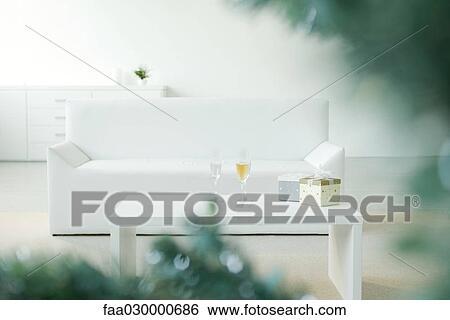 Stock Photograph - Champagne and gifts on coffee table, selective focus. Fotosearch