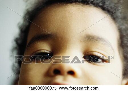 Child looking at camera, close-up of face, cropped View Large Photo Image Stock Photography - Child looking at camera, close-up of face, cropped. Fotosearch