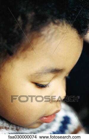 Child looking down, close-up of face, portrait View Large Photo Image Picture - Child looking down, close-up of face, portrait. Fotosearch