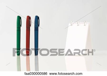 Colorful pens upright on table, notebook View Large Photo Image Stock Photograph - Colorful pens upright on table, notebook. Fotosearch