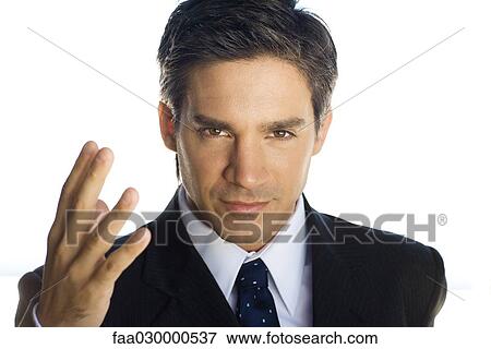 Confident businessman making hand gesture, looking at the camera, portrait View Large Photo Image Stock Photo - Confident businessman making hand gesture, looking at the camera, portrait. Fotosearch