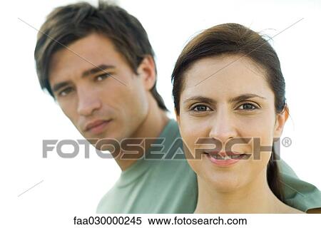 Couple looking at camera, woman smiling View Large Photo Image Stock Photography - Couple looking at camera, woman smiling. Fotosearch