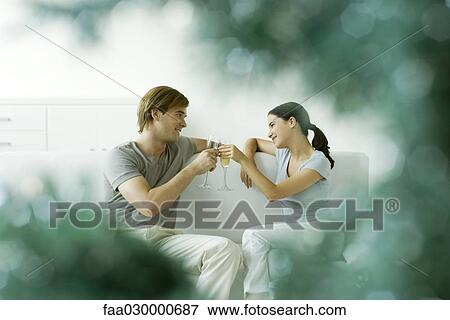 Stock Photo - Couple making a toast with champagne, selective focus. Fotosearch
