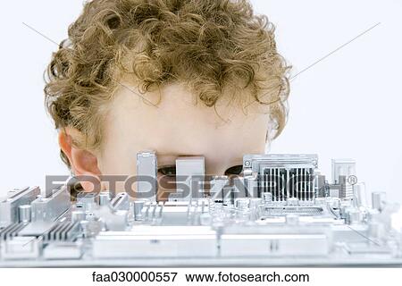 Curly haired boy hiding behind and looking through circuit board View Large Photo Image Stock Photo - Curly haired boy hiding behind and looking through circuit board. Fotosearch