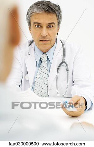 Doctor giving patient prescription drugs, over the shoulder view, cropped View Large Photo Image Stock Image - Doctor giving patient prescription drugs, over the shoulder view, cropped. Fotosearch