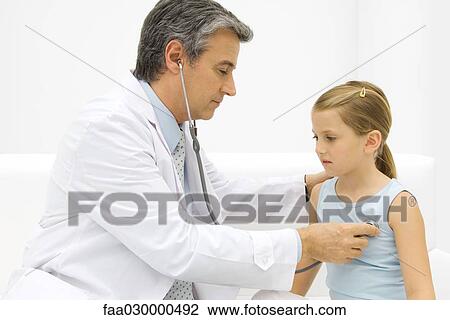 Doctor listening to little girl's heart with stethoscope, side view View Large Photo Image Stock Image - Doctor listening to little girl's heart with stethoscope, side view. Fotosearch