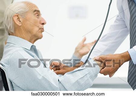 Doctor measuring senior man's pulse, cropped view View Large Photo Image Stock Image - Doctor measuring senior man's pulse, cropped view. Fotosearch