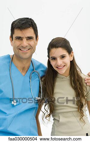 Doctor with arm around preteen girl's shoulder, both smiling at camera View Large Photo Image Picture - Doctor with arm around preteen girl's shoulder, both smiling at camera. Fotosearch