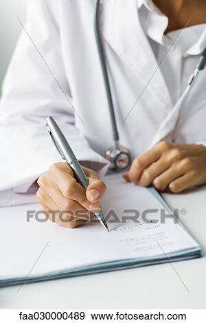 Stock Photo - Doctor writing prescription, cropped view. Fotosearch