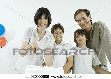 Family with birthday cake, woman holding knife, all smiling View Large Photo Image Stock Photography - Family with birthday cake, woman holding knife, all smiling. Fotosearch