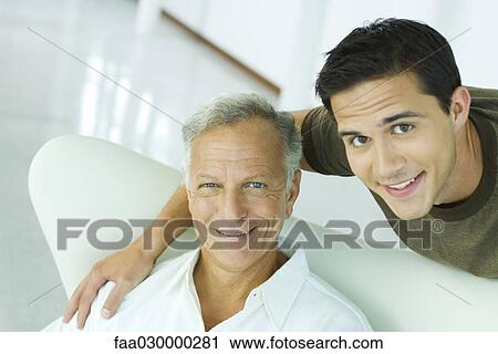 Father and adult son smiling at camera, portrait View Large Photo Image Stock Image - Father and adult son smiling at camera, portrait. Fotosearch