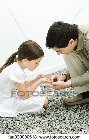 Father and daughter looking at gravel together View Large Photo Image Stock Photo - Father and daughter looking at gravel together. Fotosearch